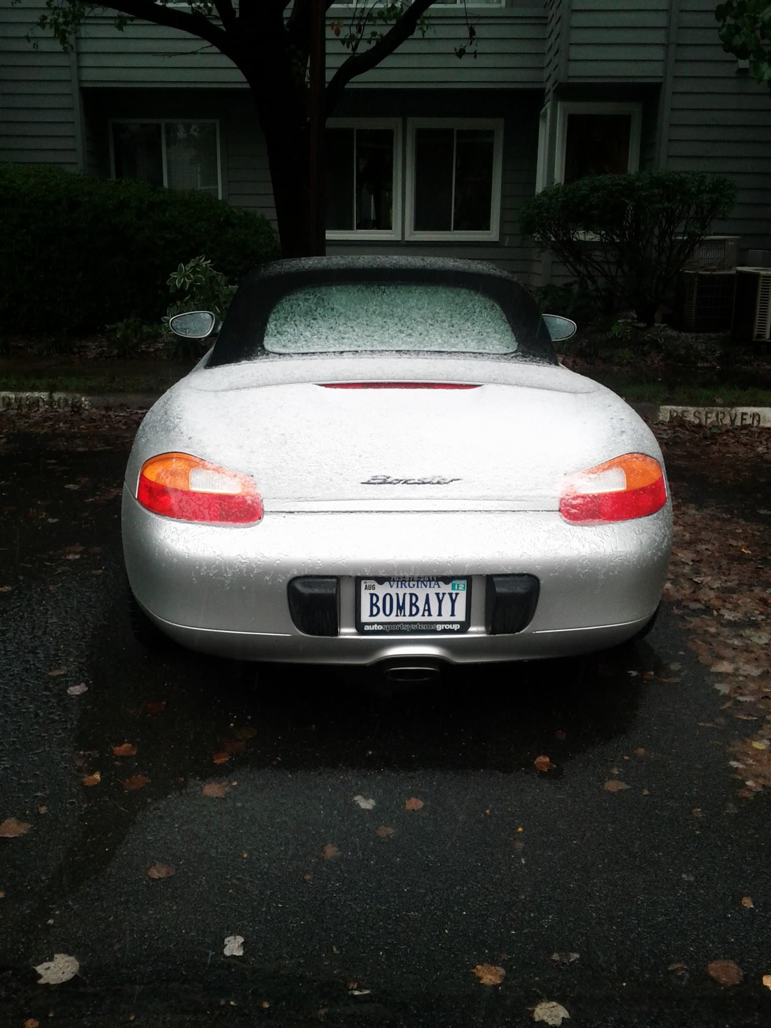 The rear of my silver Porsche Boxster with its BOMBAYY vanity plate.