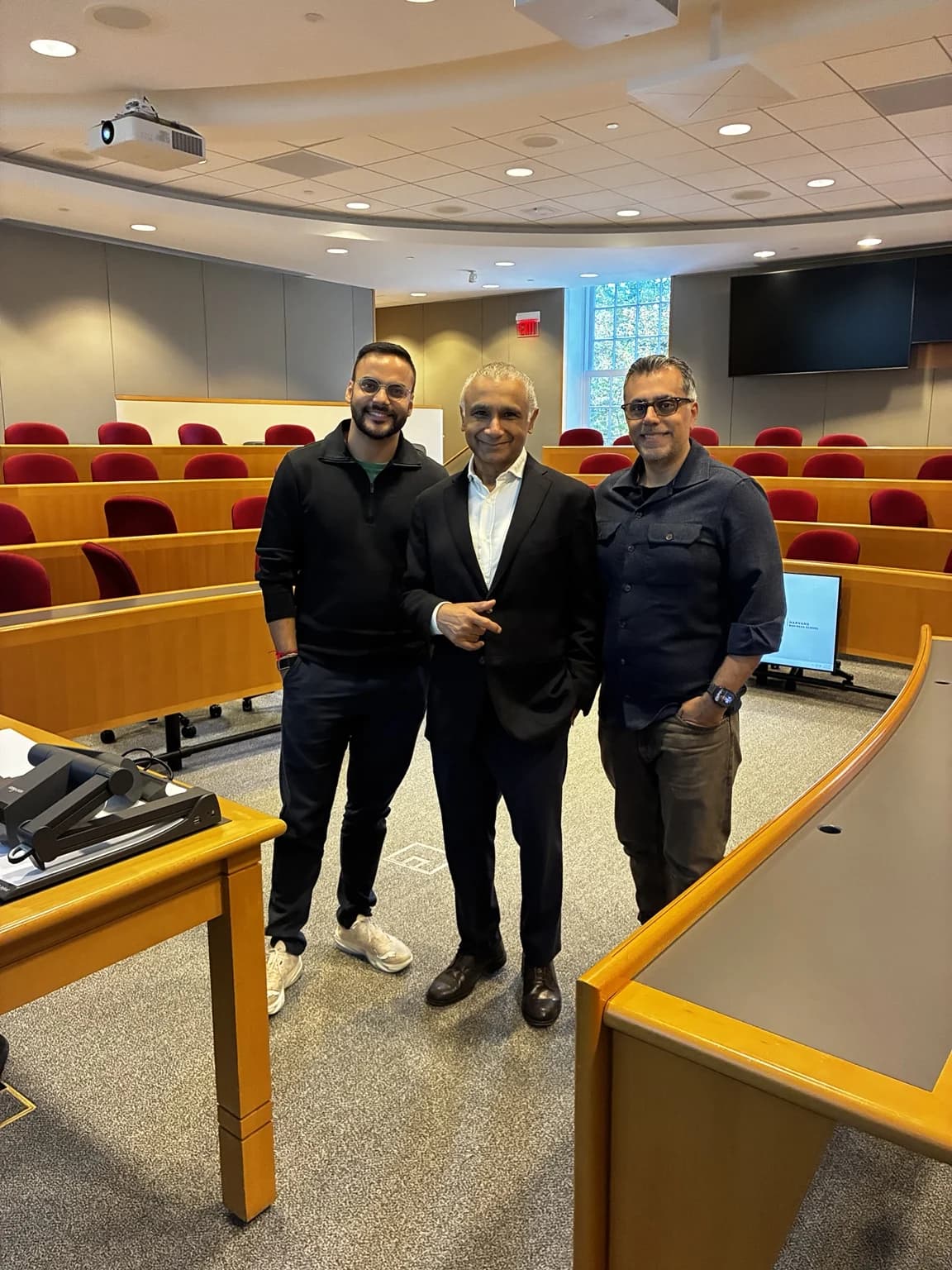 Robin Singhvi, Prof Ghosh and Vinay standing in a Harvard Business School classroom.